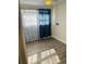 Spacious bedroom with hardwood floors and blue curtains at 415 Avenue K Ne, Winter Haven, FL 33881