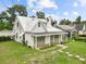 Exterior view of the house shows well-maintained lawn and inviting porch at 415 Avenue K Ne, Winter Haven, FL 33881