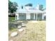 Home with a metal roof features a welcoming porch, and stone walkway at 415 Avenue K Ne, Winter Haven, FL 33881