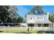Charming cottage with metal roof, white picket fence, and landscaped yard at 415 Avenue K Ne, Winter Haven, FL 33881