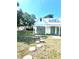 Charming home exterior with white siding, green trim, and stepping stone pathway at 415 Avenue K Ne, Winter Haven, FL 33881