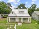This charming home features a metal roof, and welcoming front porch at 415 Avenue K Ne, Winter Haven, FL 33881