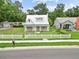 Charming home with a metal roof, inviting porch, and well-kept front lawn at 415 Avenue K Ne, Winter Haven, FL 33881