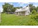 Charming home featuring a white exterior, metal roof, and a cozy front porch at 415 Avenue K Ne, Winter Haven, FL 33881
