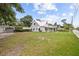 Exterior shot of the house with a spacious front yard, garage, and fence at 415 Avenue K Ne, Winter Haven, FL 33881
