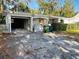 Home's exterior featuring a detached garage with a long driveway at 415 Avenue K Ne, Winter Haven, FL 33881
