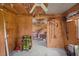 Cluttered unfinished garage featuring open walls, storage, and concrete flooring at 415 Avenue K Ne, Winter Haven, FL 33881