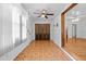 Hallway features tiled floor, white walls, and access to other rooms at 415 Avenue K Ne, Winter Haven, FL 33881