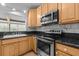 Close up of kitchen with stainless steel oven and microwave, with granite countertops at 415 Avenue K Ne, Winter Haven, FL 33881