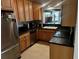 Galley kitchen with dark countertops, stainless steel appliances, and wood cabinets at 415 Avenue K Ne, Winter Haven, FL 33881