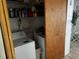 Bright laundry room with washer, dryer and shelving at 415 Avenue K Ne, Winter Haven, FL 33881