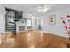Living room showcasing a spiral staircase, fireplace, and hardwood floors at 415 Avenue K Ne, Winter Haven, FL 33881