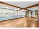 Bright living room boasts wood beams, large windows, and wood floors at 415 Avenue K Ne, Winter Haven, FL 33881
