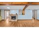 Open living room with fireplace, wood floors, and multiple entryways at 415 Avenue K Ne, Winter Haven, FL 33881