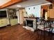 Living room with hardwood floors, a fireplace, and built-in shelving at 415 Avenue K Ne, Winter Haven, FL 33881