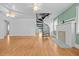 Bright living room featuring a spiral staircase, hardwood floors, and decorative fireplace at 415 Avenue K Ne, Winter Haven, FL 33881