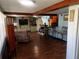 Open living area with hardwood floors and a view into the kitchen at 415 Avenue K Ne, Winter Haven, FL 33881