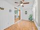 Cozy room featuring tiled floors, ceiling fan, and an archway leading to the fireplace at 415 Avenue K Ne, Winter Haven, FL 33881