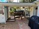 Brick patio with a ramp, bird bath, and grill at 415 Avenue K Ne, Winter Haven, FL 33881