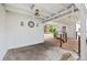 An enclosed patio includes a ceiling fan, wood plank ceiling and provides access to the backyard at 415 Avenue K Ne, Winter Haven, FL 33881