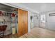 Functional utility room with laundry hookups, storage shelves, and access to backyard at 415 Avenue K Ne, Winter Haven, FL 33881