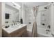 Updated bathroom with a neutral color palette and bathtub shower combo at 521 W Voorhis Ave, Deland, FL 32720