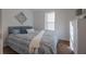 Cozy bedroom with a bed and dresser, featuring a stylish wall decor at 521 W Voorhis Ave, Deland, FL 32720
