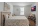 Bedroom with a queen bed and a bench at the foot of the bed at 521 W Voorhis Ave, Deland, FL 32720