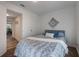 Comfortable bedroom with a bed and access to hallway at 521 W Voorhis Ave, Deland, FL 32720
