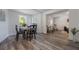 Bright dining room features a round wooden table with four chairs and hardwood floors at 521 W Voorhis Ave, Deland, FL 32720