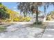 Tan house exterior with a yard and large tree at 521 W Voorhis Ave, Deland, FL 32720