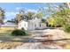 Tan house exterior with a yard and trees at 521 W Voorhis Ave, Deland, FL 32720