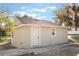 Tan house exterior with white door and window at 521 W Voorhis Ave, Deland, FL 32720
