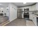 Modern kitchen with stainless steel appliances and white cabinets at 521 W Voorhis Ave, Deland, FL 32720