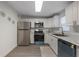 Modern kitchen with stainless steel appliances and white shaker cabinets at 521 W Voorhis Ave, Deland, FL 32720