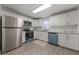 Modern kitchen with stainless steel appliances and white shaker cabinets at 521 W Voorhis Ave, Deland, FL 32720
