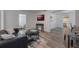 Living room with a black leather couch and hardwood floors at 521 W Voorhis Ave, Deland, FL 32720