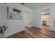 Living room with hardwood floors and view into kitchen and hallway at 521 W Voorhis Ave, Deland, FL 32720