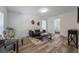 Bright living room with modern sofa, coffee table, and stylish chair at 521 W Voorhis Ave, Deland, FL 32720
