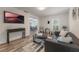 Spacious living room with a black leather couch and large TV at 521 W Voorhis Ave, Deland, FL 32720