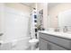 Bathroom with a bathtub, shower, and gray vanity at 601 Drop Shot Dr, Davenport, FL 33896
