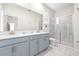 Double vanity bathroom with a large shower and marble flooring at 601 Drop Shot Dr, Davenport, FL 33896