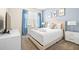 Bedroom with a queen-size bed and light blue walls at 601 Drop Shot Dr, Davenport, FL 33896