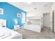 Bedroom with a full-size bed, bunk beds, and a blue accent wall at 601 Drop Shot Dr, Davenport, FL 33896