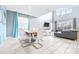 Open concept dining area with high ceilings, gray sofa and view of the kitchen at 601 Drop Shot Dr, Davenport, FL 33896