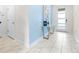 Bright entryway with light tile floors, a console table, and blue accent wall at 601 Drop Shot Dr, Davenport, FL 33896