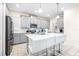 Modern kitchen with gray cabinets, white countertops, and an island with seating at 601 Drop Shot Dr, Davenport, FL 33896