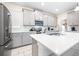 Modern kitchen with gray cabinets, white countertops, and stainless steel appliances at 601 Drop Shot Dr, Davenport, FL 33896