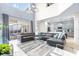 Open living room with sectional sofa, high ceilings, and view of the kitchen and pool at 601 Drop Shot Dr, Davenport, FL 33896