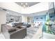 Spacious living room with a gray sectional sofa, high ceilings, and a view of the kitchen at 601 Drop Shot Dr, Davenport, FL 33896